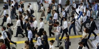 Fearing Olympic chaos, Tokyo tells workers: stay home
