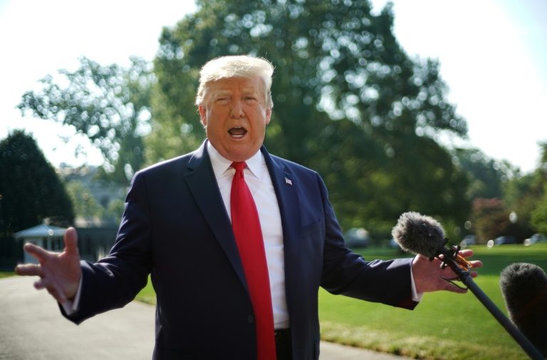 Trump denies stoking extremism on visit to massacre sites