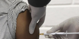 Nurse Jeanne Dusungu is vaccinating anyone who turns up to the white Unicef tent in the grounds of North Kivu provincial hospital in Goma against Covid-19